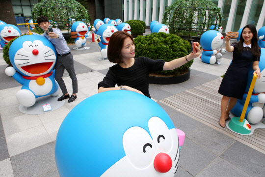 25일 경기 성남 현대백화점 판교점 앞 도라에몽파크에서 고객들이 기념촬영을 하고 있다. <현대백화점 제공>